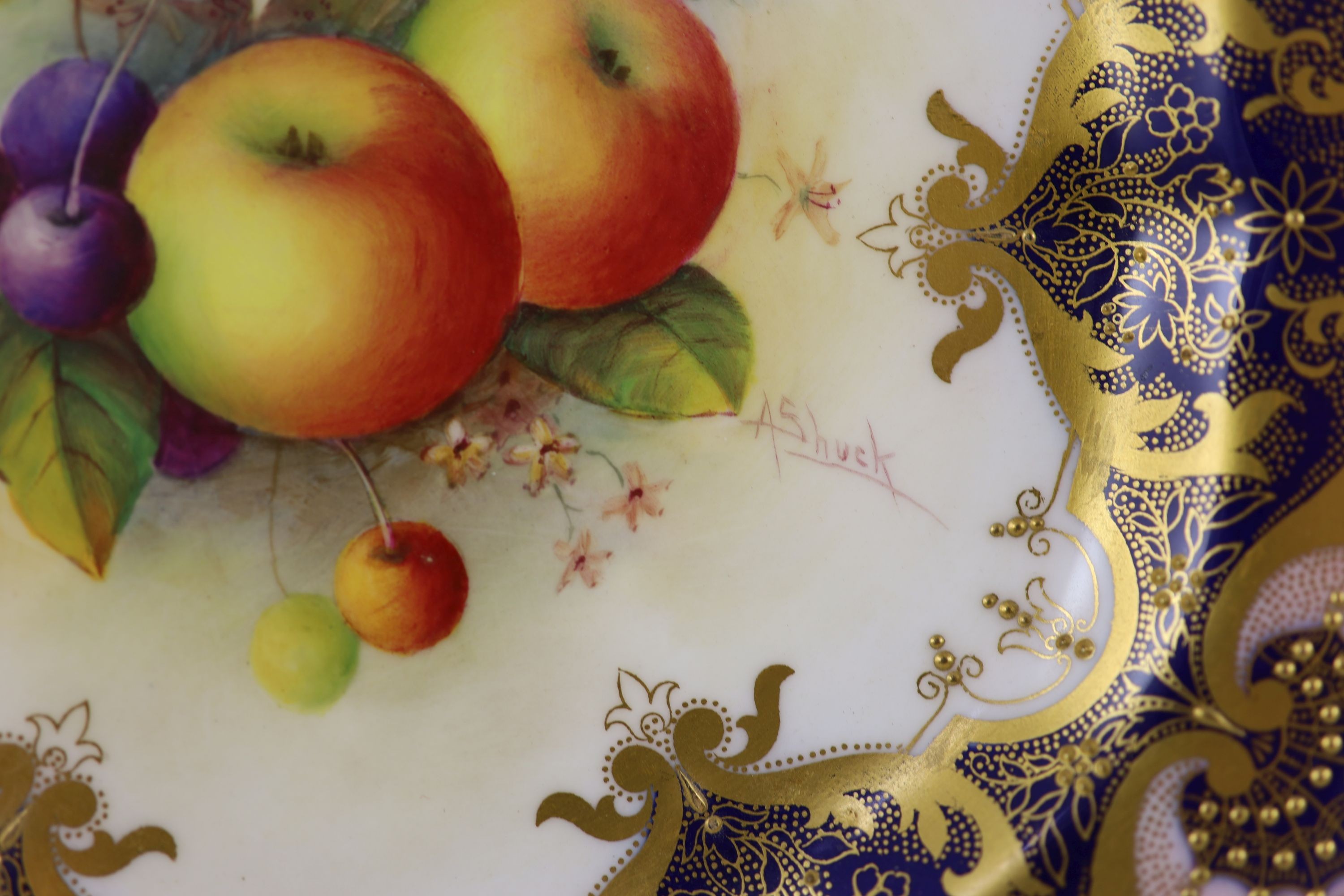 A pair of Royal Worcester fruit painted dessert plates, signed A. Shuck, c.1918 and 1935, cm diameter